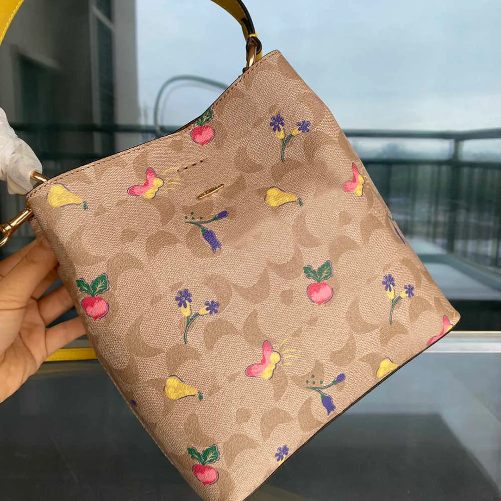 COACH Radiant Petal Floral Print Bucket Bag with Citrus Burst Accents