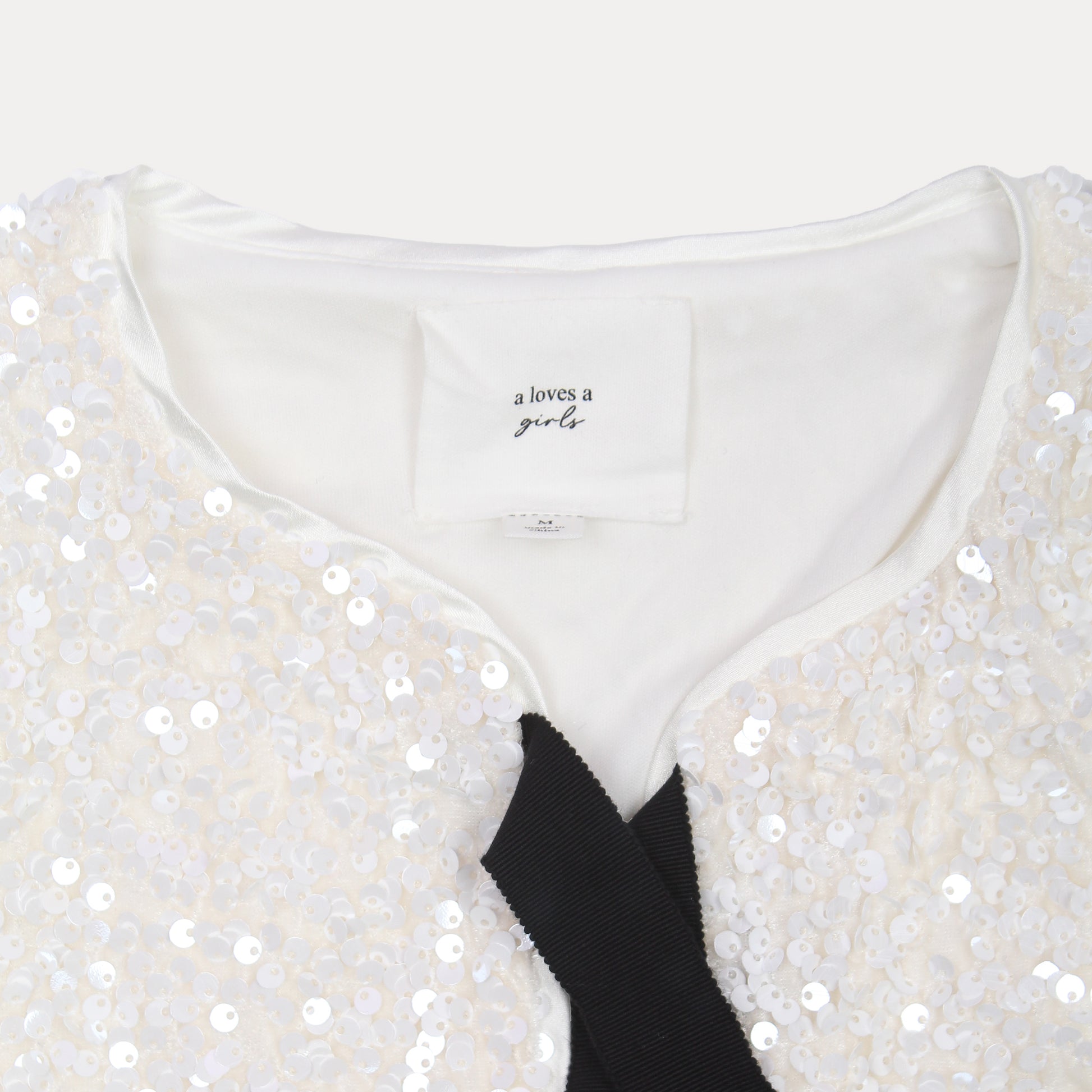 A Loves A Sparkling Cream Sequin Cropped Jacket with Elegant Black Tie